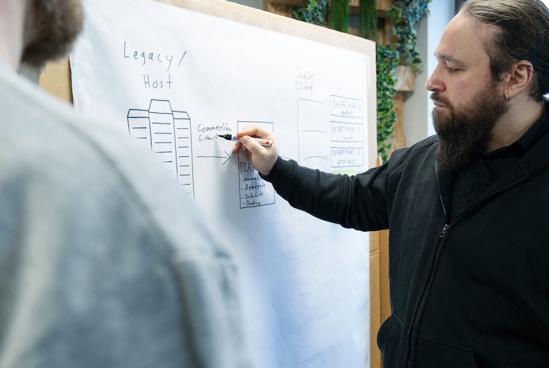 A person writing on a board